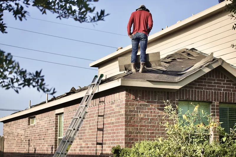 Professional roofer working on a residential roof in Sabarto East